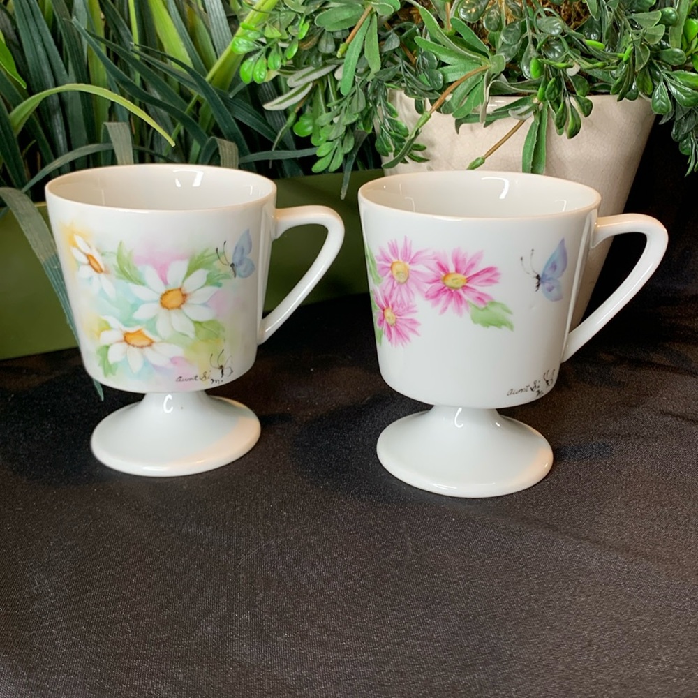 Set of 2 vintage hand painted and signed floral and butterfly footed mugs / cups